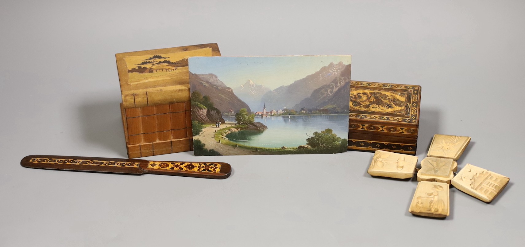 A 19th century Swiss oil on panel, a Tunbridgeware box and paperknife and other wood wares